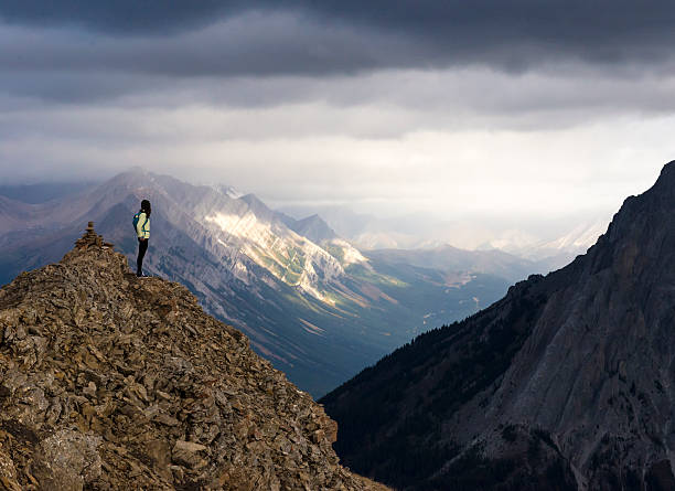 istock Female hiker looking at out from mountain peak 614740832