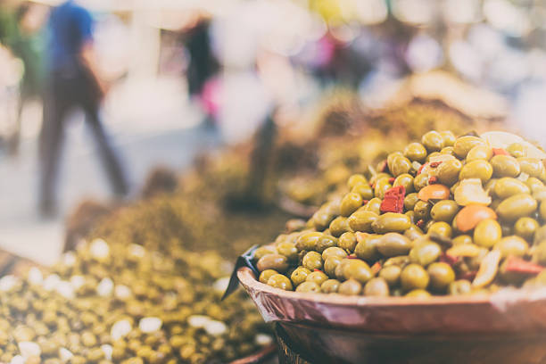 Close up shot of olives for sale in an outdoors marketplace