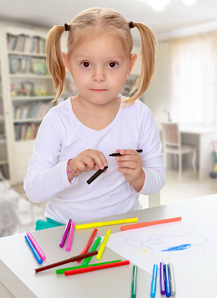 istock The girl draws with markers 614741814