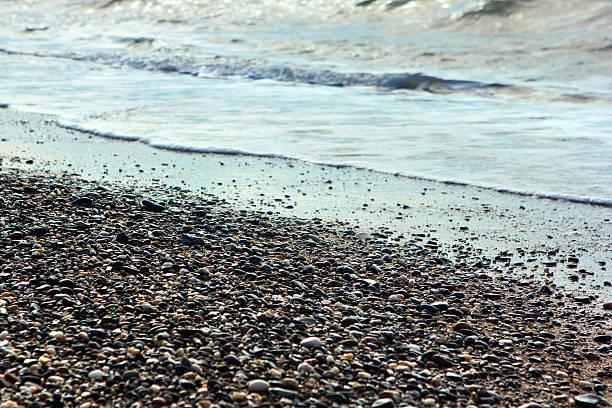 istock Sea edge, sunset light, stony shore, surf. 614742228
