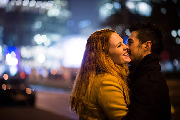 Love - couple hugging in street at night stock photo