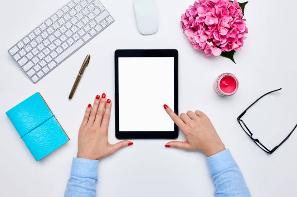 istock Blogger using digital tablet by desk supplies against white back 614745428