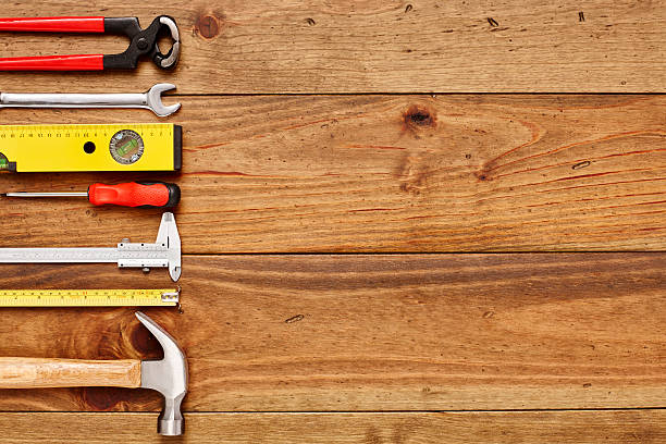 istock Various carpentry tools arranged on left side of wooden floor 614745528