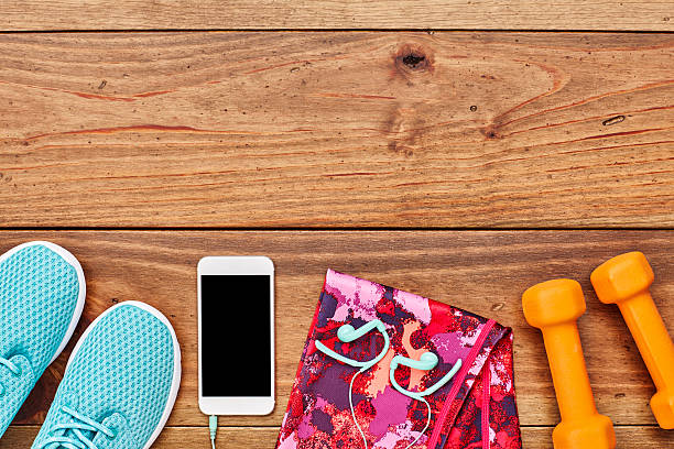 istock Exercise equipment with smart phone on hardwood floor 614746210