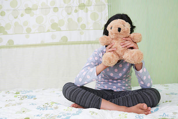 istock Girl with teddy bear 614747176