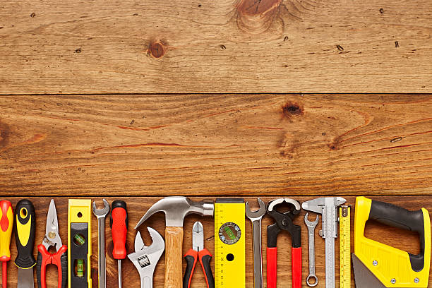 istock Close-up of various hand tools on wooden floor 614747210