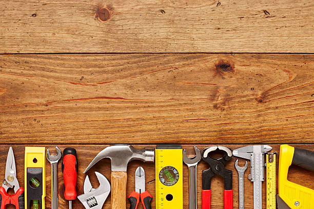 istock Various work tools on left side of wooden floor 614747300