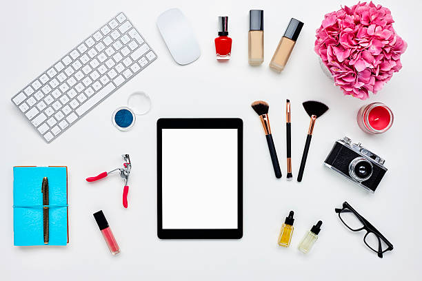 istock Digital tablet with beauty products on bloggers desk 614747512