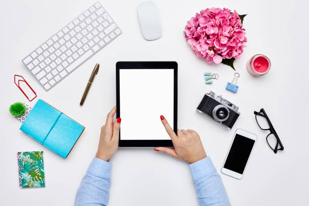 istock Bloggers's hand using digital tablet wearing red polish 614748180