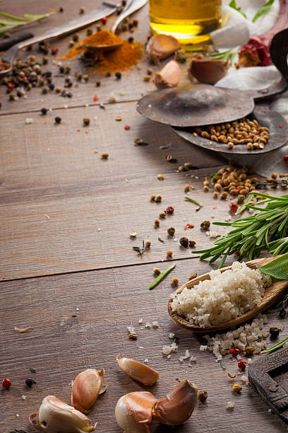 istock Various herbs and spices on dark wood table 614748252