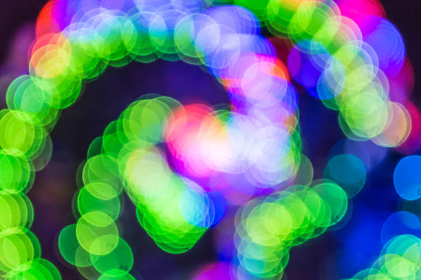 istock Colorful spiral LED bokeh background 614748400