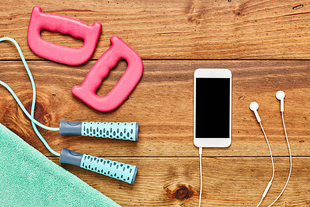 istock Jump rope with smart phone  handles and towel on floor 614749120