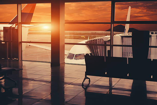 istock Plane in airport near jet bridge. View from inside 614749416