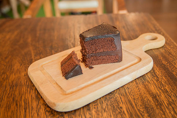 istock Close up Slice of chocolate cake on wood table. 614832294