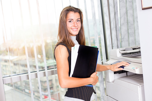 Young  woman using a photocopier