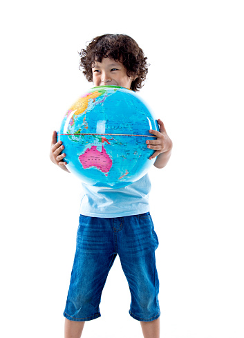 Young asian boy holding a globe against white background.