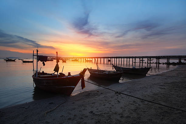 istock Small fishing boats moored beached 614833032