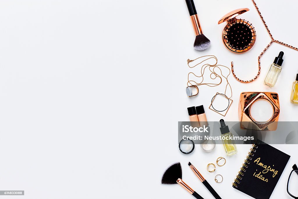 Various beauty products and jewelry against white background Directly above shot of various beauty products and jewelry. Personal accessories are placed on white background. The blank space can be used for advertisement purpose. Make-Up Stock Photo