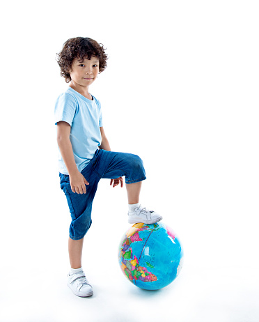 Young asian boy with a globe against white background.