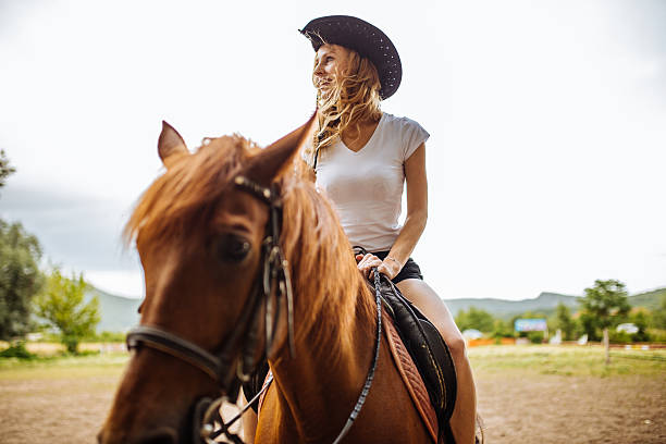 istock Cowgirl riding a horse 614833272