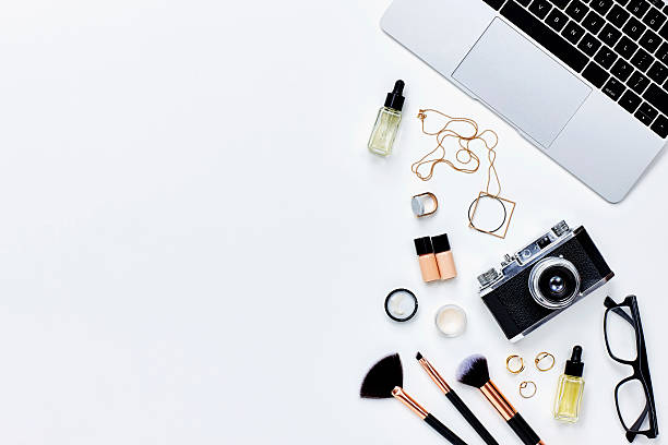 istock Various beauty products with camera and laptop on white background 614833318