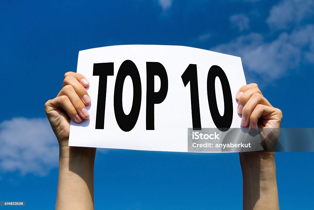 top 10 top 10, hands holding sign in blue sky Top Ten List Stock Photo