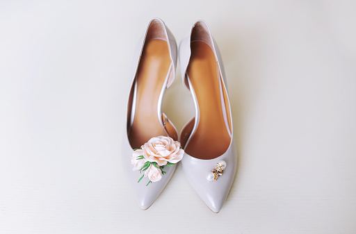 Female wedding footwear isolated over white background.