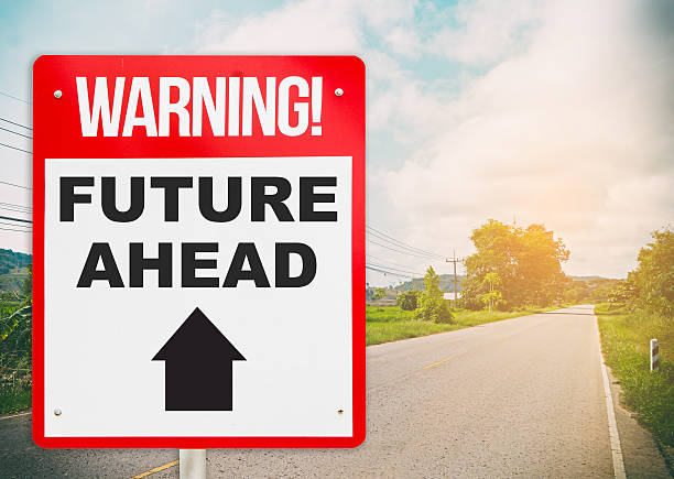 istock Warning sign with Future Ahead on a bright road. 614834390