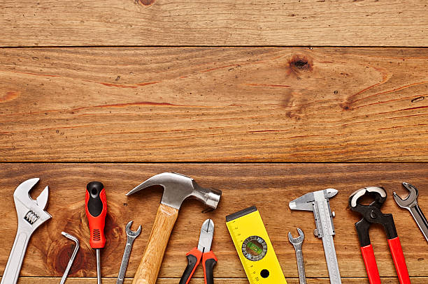 istock Directly above shot of various carpentry tools on wooden floor 614835202