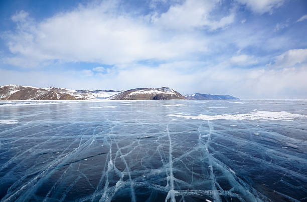 istock Winter ice landscape on Siberian lake Baikal with clouds 614835278