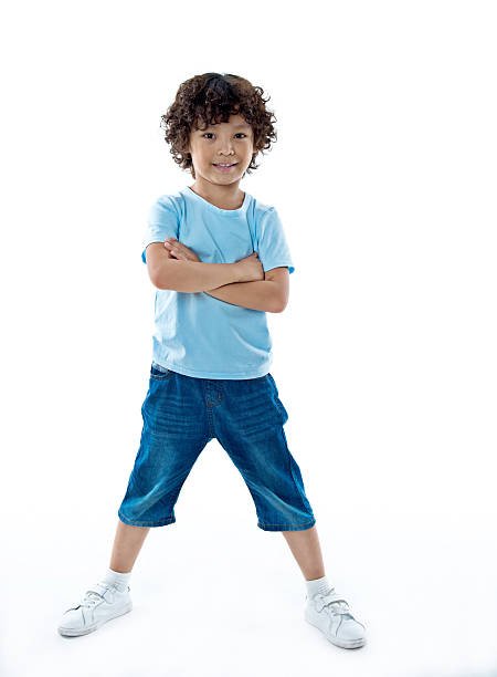 smiling young boy standing against white background - six objects imagens e fotografias de stock