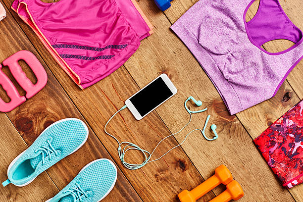 istock Smart phone surrounded with exercise equipment on hardwood floor 614836790
