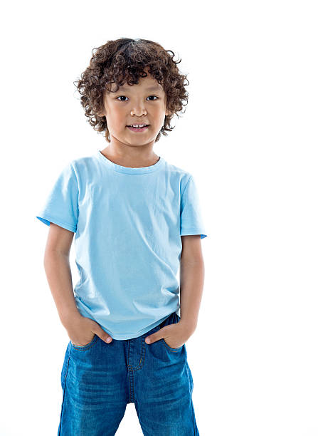 istock Smiling young boy standing against white background 614836940
