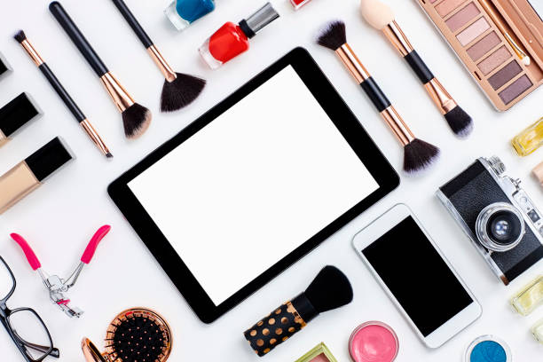 istock Flat lay beauty products surrounding digital tablet on white desk 614837390