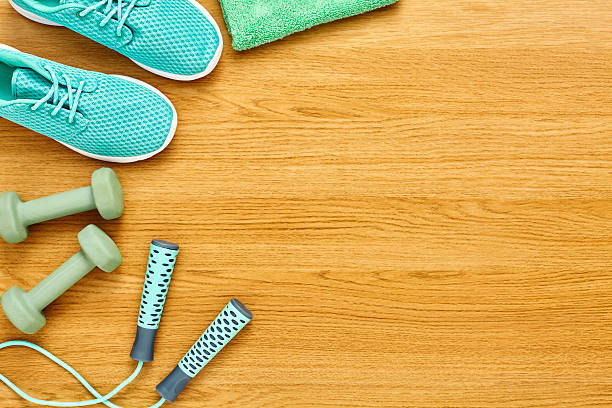 istock Flat Lay of various exercise equipment on hardwood floor 614837484
