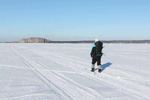 istock The man the traveler with a backpack skiing on snow 614837950