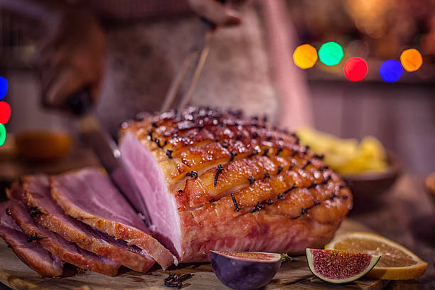 istock Carving Glazed Holiday Ham with Cloves 614838050