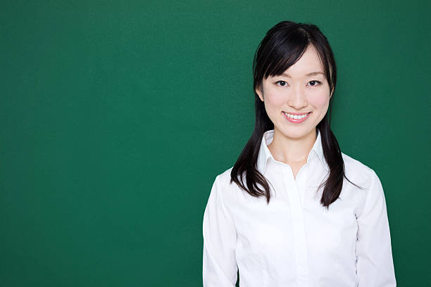 istock Teacher standing in front of blackboard 614838128