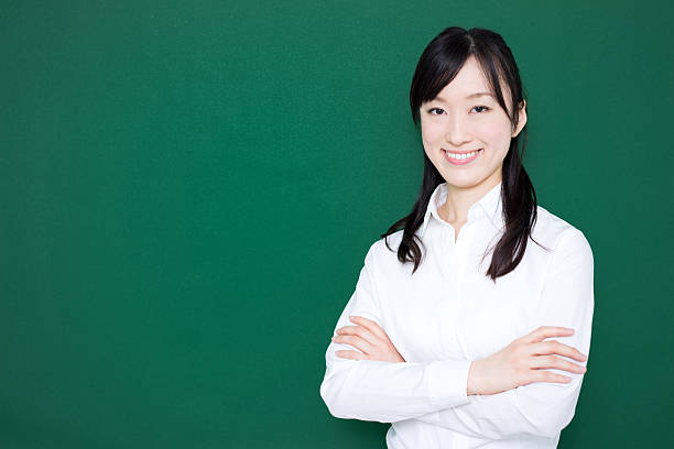 istock Teacher standing in front of blackboard 614838430