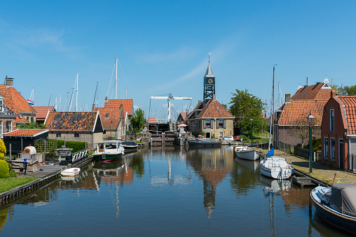 Hindeloopen, The Netherlands - May 21, 2015: Picturesque buildings, harbor and church in Hindeloopen at the IJsselmeer with in province Friesland near Lemmer, The Netherlands.