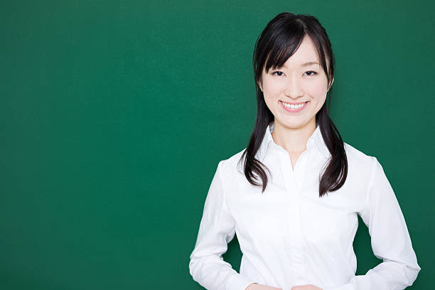 istock Teacher standing in front of blackboard 614839098