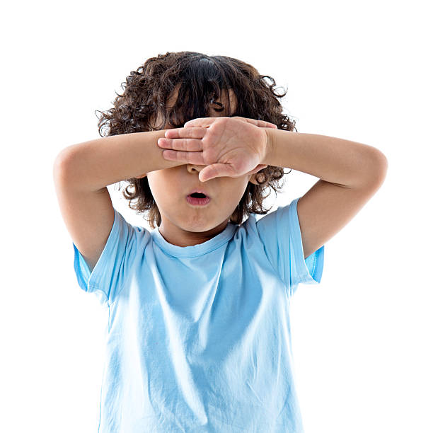 istock Little asian boy covering eyes against white background 614840066