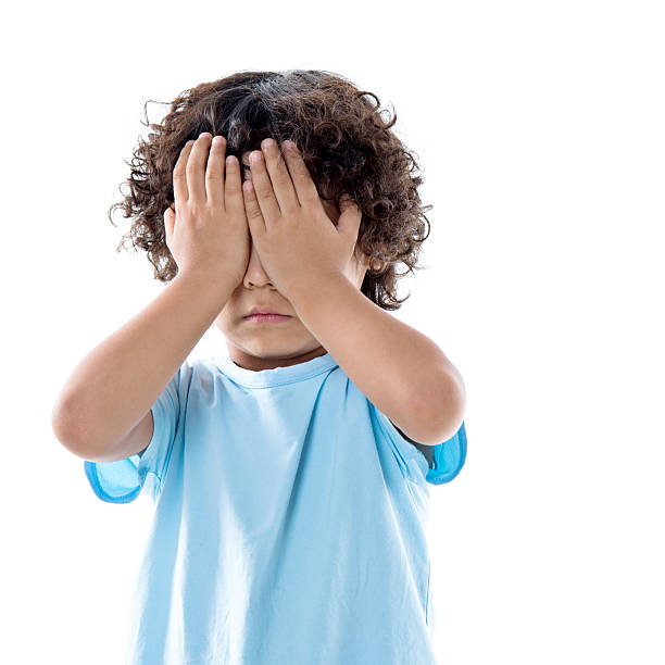 istock Little asian boy covering eyes against white background 614840196