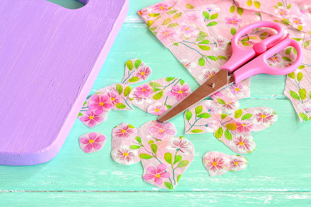 Decorative painted chopping board Cut pieces of napkins. Scissors, flowers napkin fragments. Decoupage tutorial - decorating kitchen cutting board decoupage stock pictures, royalty-free photos & images