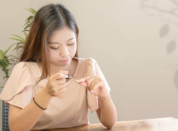 istock Young female painting nails. 614841800