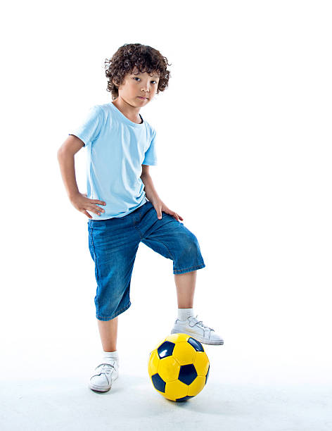istock Little boy playing football 614843568