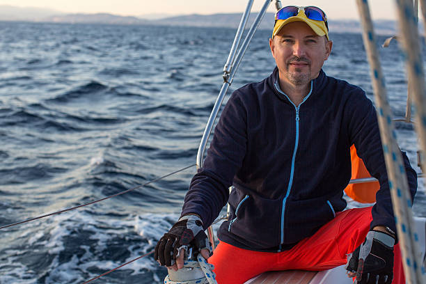 istock Man sitting on a sailing yacht at sea. 614843720