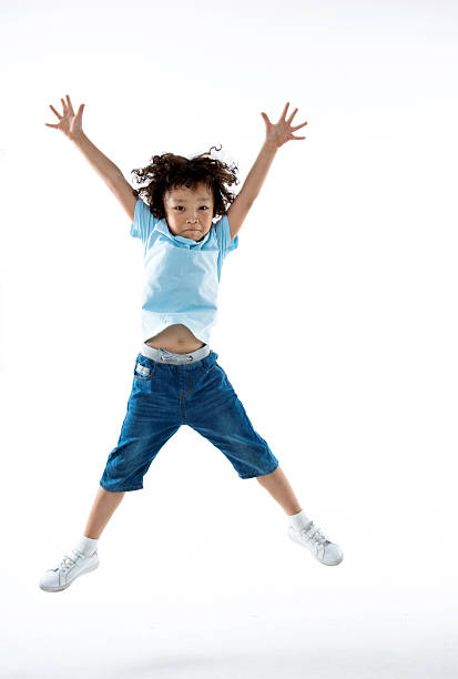 istock Little boy jumping isolated on white background 614844600