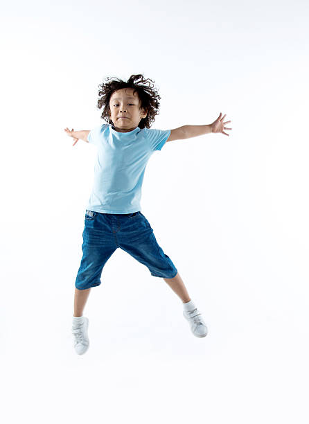 istock Little boy jumping isolated on white background 614844862