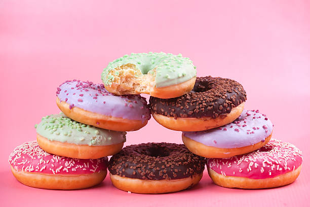 istock Sweet colorful tasty donuts on pink background. 614844976